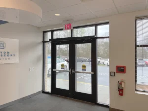 Commercial entry doors with panic hardware in a facility where a commercial door closer helps support safe, controlled operation