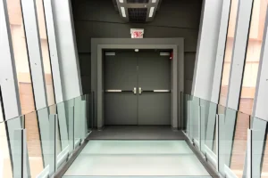 Pair of commercial steel doors with panic hardware installed in a modern commercial corridor