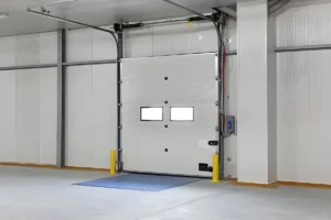Commercial garage door interior with a sealed threshold area in a clean industrial facility