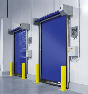 Blue commercial overhead doors inside a warehouse facility, related to garage door sensor repair and commercial door safety systems.