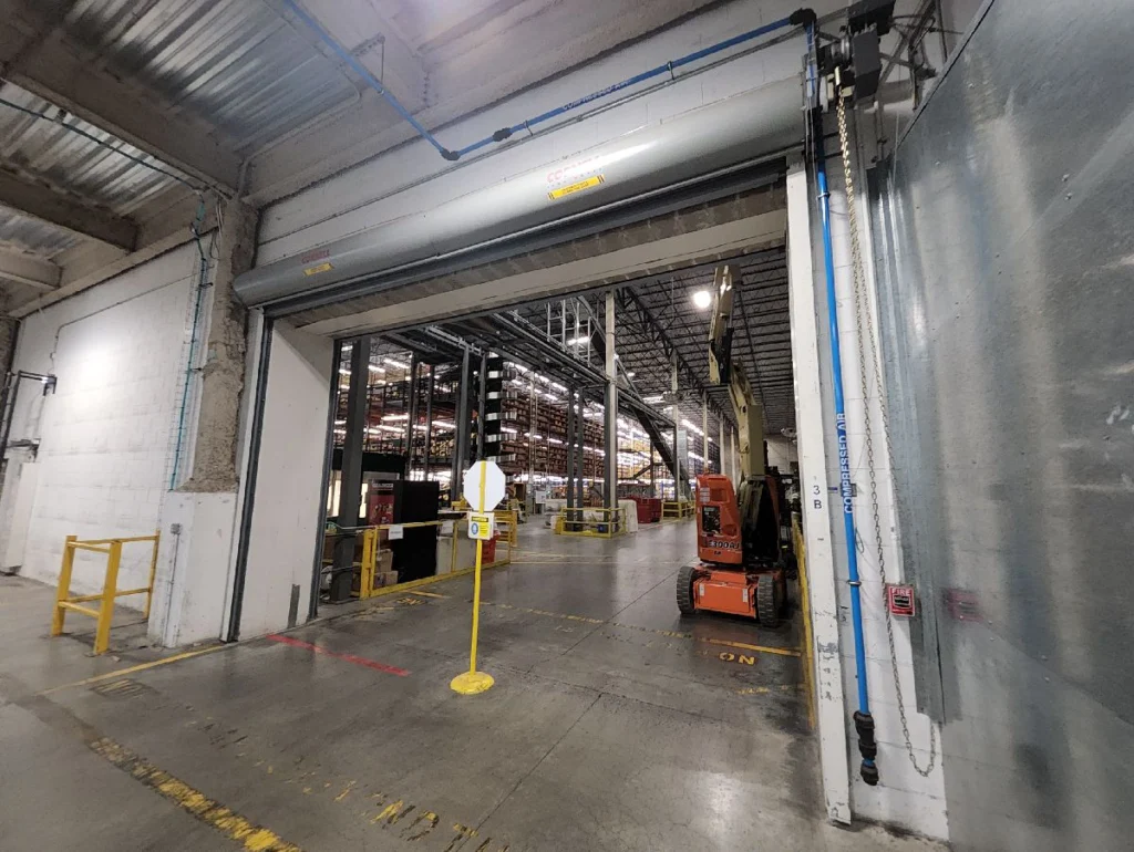 Fire-rated rolling steel doors installed inside a commercial warehouse opening
